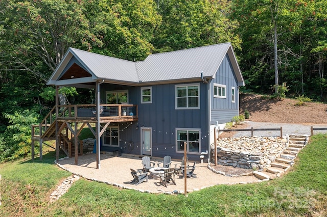 54 Weldon Way, Fairview, NC 28730 - back of property with an outdoor fire pit, a patio area, stairs, a wooden deck, and a yard