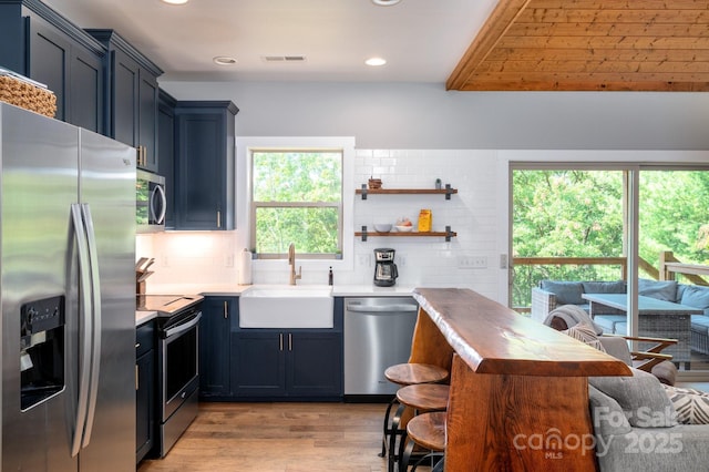 54 Weldon Way, Fairview, NC 28730 - kitchen featuring appliances with stainless steel finishes, light wood-style flooring, recessed lighting, a breakfast bar area, and backsplash