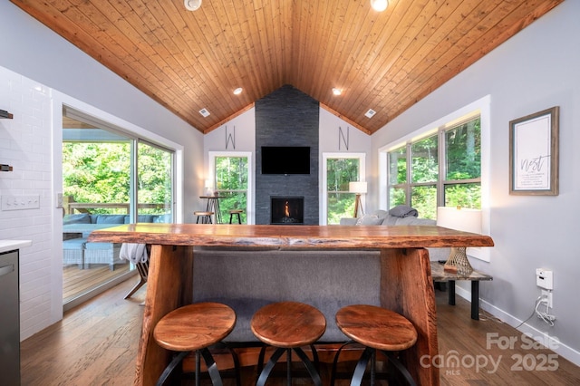 54 Weldon Way, Fairview, NC 28730 - kitchen with vaulted ceiling, a fireplace, wood finished floors, wooden ceiling, and a breakfast bar