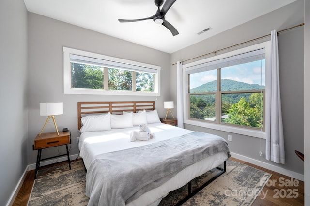 54 Weldon Way, Fairview, NC 28730 - bedroom with multiple windows, wood finished floors, a mountain view, and a ceiling fan