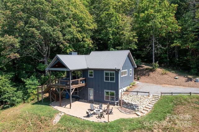 54 Weldon Way, Fairview, NC 28730 - rear view of property with board and batten siding, a fire pit, a patio, a deck, and stairs