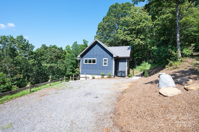 54 Weldon Way, Fairview, NC 28730 - view of front facade featuring a metal roof, board and batten siding, and gravel driveway