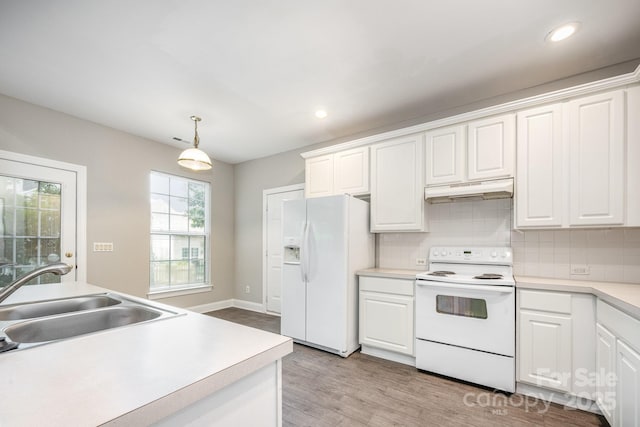 6721 Charter Hills Rd, Charlotte, NC 28277 - kitchen with white appliances, under cabinet range hood, light wood-type flooring, white cabinets, and recessed lighting