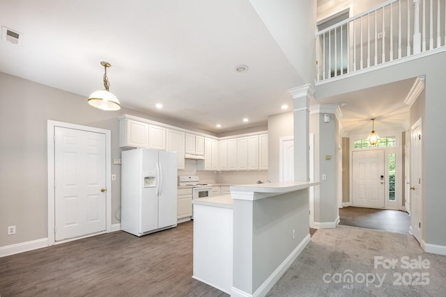 6721 Charter Hills Rd, Charlotte, NC 28277 - kitchen with white appliances, light countertops, white cabinetry, recessed lighting, and hanging light fixtures
