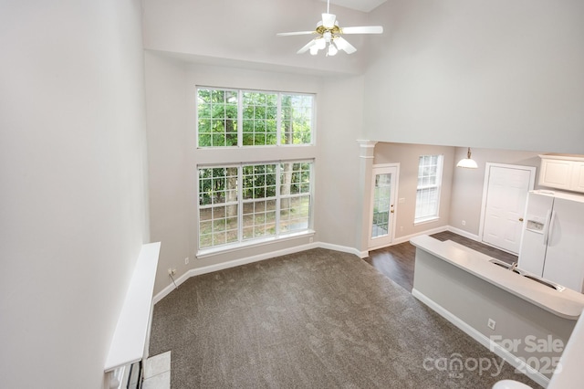 6721 Charter Hills Rd, Charlotte, NC 28277 - unfurnished living room with a high ceiling, a ceiling fan, and dark carpet