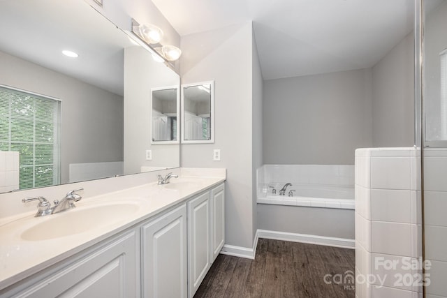 6721 Charter Hills Rd, Charlotte, NC 28277 - full bathroom with wood finished floors, double vanity, and a bath