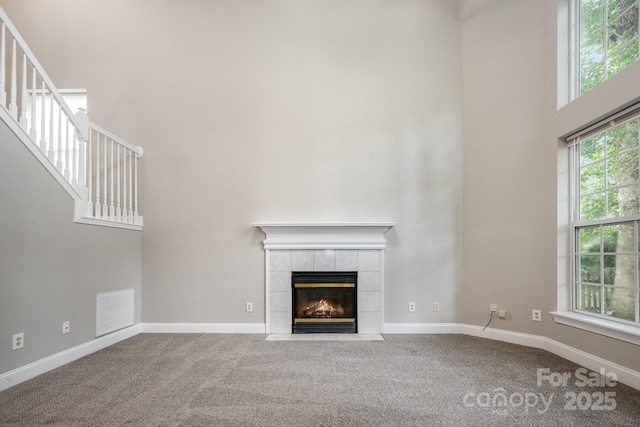 6721 Charter Hills Rd, Charlotte, NC 28277 - unfurnished living room with carpet flooring, a fireplace, a high ceiling, and stairway
