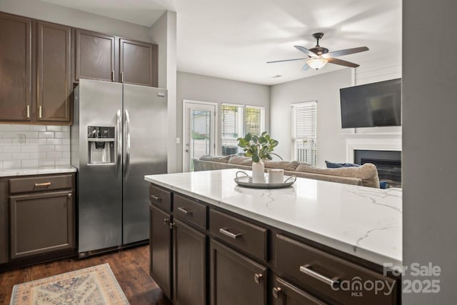 9846 Bailey Rd, Cornelius, NC 28031 - kitchen with stainless steel refrigerator with ice dispenser, open floor plan, ceiling fan, dark wood-type flooring, and tasteful backsplash
