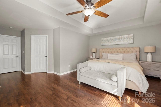 9846 Bailey Rd, Cornelius, NC 28031 - bedroom with wood finished floors, a tray ceiling, and a ceiling fan