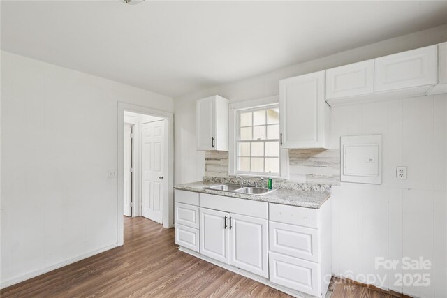 1208 Arch St E Unit 10, Lancaster, SC 29720 - kitchen with light countertops, wood finished floors, and white cabinetry