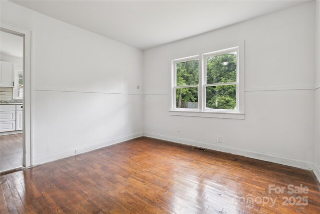 1208 Arch St E Unit 10, Lancaster, SC 29720 - spare room featuring hardwood / wood-style flooring and baseboards