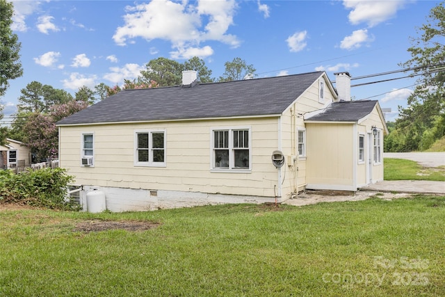 1208 Arch St E Unit 10, Lancaster, SC 29720 - view of side of property featuring a chimney, a yard, roof with shingles, and cooling unit