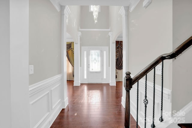 12515 Hashanli Pl, Matthews, NC 28105 - foyer featuring a decorative wall, wainscoting, stairway, a chandelier, and dark wood finished floors