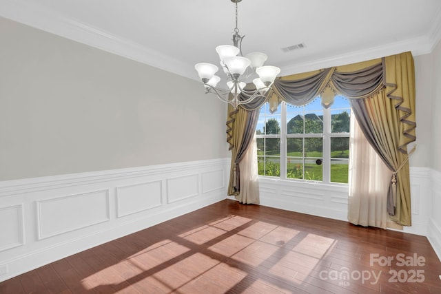 12515 Hashanli Pl, Matthews, NC 28105 - unfurnished dining area with a chandelier, dark wood-style floors, wainscoting, and ornamental molding