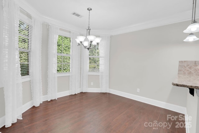 12515 Hashanli Pl, Matthews, NC 28105 - unfurnished dining area with ornamental molding, a chandelier, and dark wood-type flooring