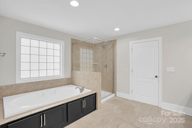 12515 Hashanli Pl, Matthews, NC 28105 - bathroom with a garden tub, a stall shower, and recessed lighting