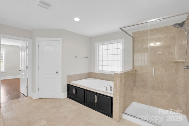 12515 Hashanli Pl, Matthews, NC 28105 - full bathroom with a bath, a shower stall, and recessed lighting