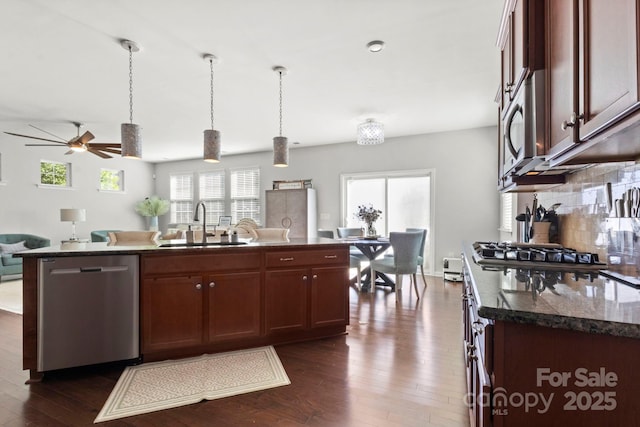 2005 Brightflower Ln, York, SC 29745 - kitchen with stainless steel appliances, dark wood-style floors, ceiling fan, and backsplash
