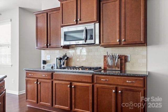 2005 Brightflower Ln, York, SC 29745 - kitchen with stainless steel appliances, dark wood-type flooring, tasteful backsplash, and dark stone counters