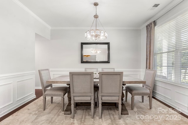 2005 Brightflower Ln, York, SC 29745 - dining room with a chandelier, ornamental molding, wood finished floors, a decorative wall, and wainscoting