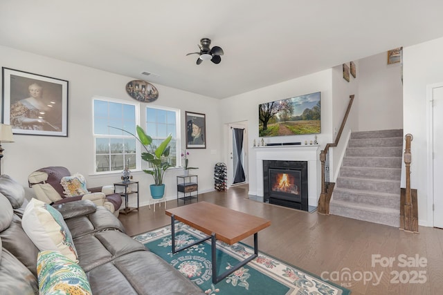 3013 Whipcord Dr, Waxhaw, NC 28173 - living area featuring wood finished floors, stairs, and a fireplace with flush hearth