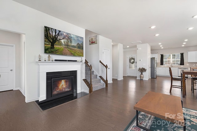 3013 Whipcord Dr, Waxhaw, NC 28173 - living area with dark wood-type flooring, stairway, recessed lighting, and a glass covered fireplace