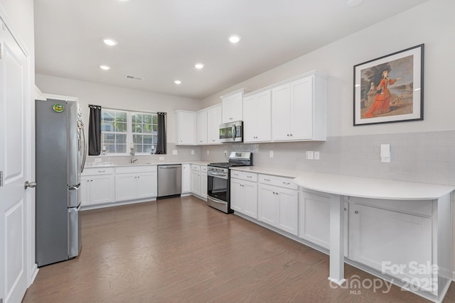 3013 Whipcord Dr, Waxhaw, NC 28173 - kitchen featuring stainless steel appliances, dark wood-style flooring, light countertops, white cabinets, and recessed lighting