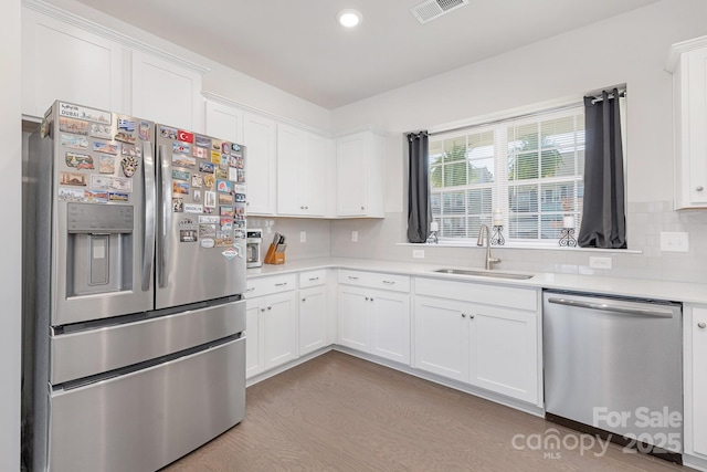 3013 Whipcord Dr, Waxhaw, NC 28173 - kitchen with appliances with stainless steel finishes, light countertops, decorative backsplash, white cabinets, and recessed lighting