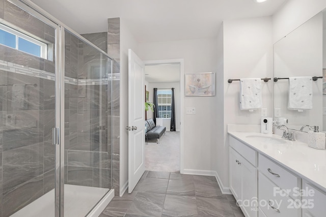 3013 Whipcord Dr, Waxhaw, NC 28173 - full bath with marble look tile flooring, vanity, plenty of natural light, and a stall shower