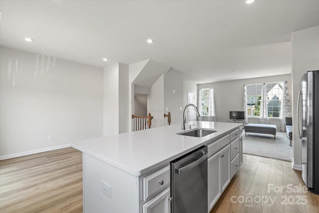 512 Whitehall Cir, Durham, NC 27713 - kitchen with stainless steel appliances, open floor plan, light wood-type flooring, a kitchen island with sink, and recessed lighting