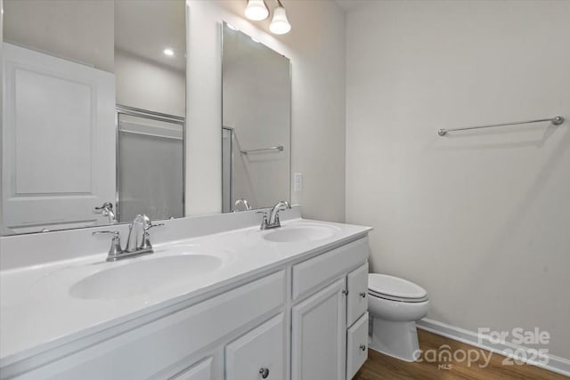 512 Whitehall Cir, Durham, NC 27713 - bathroom with double vanity, wood finished floors, and a shower