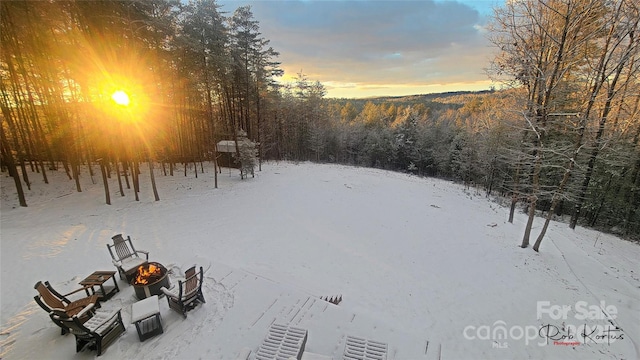 1594 High Valley Way, Lenoir, NC 28645 - yard covered in snow featuring an outdoor fire pit and a wooded view