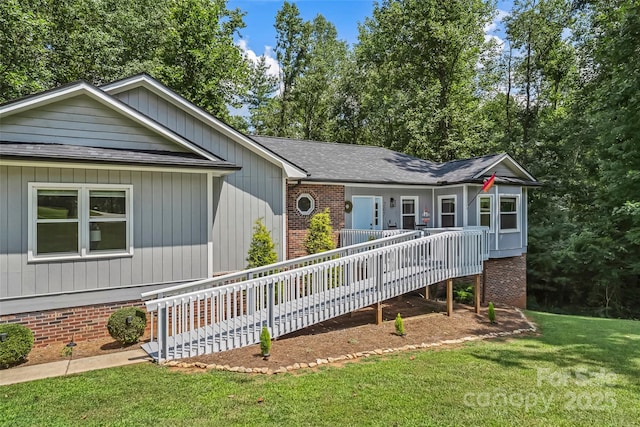 207 Jacksons Run, Morganton, NC 28655 - view of front of home with brick siding, a front lawn, roof with shingles, and a deck