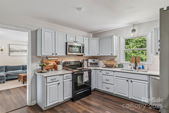 207 Jacksons Run, Morganton, NC 28655 - kitchen with appliances with stainless steel finishes, light countertops, dark wood-type flooring, and white cabinetry