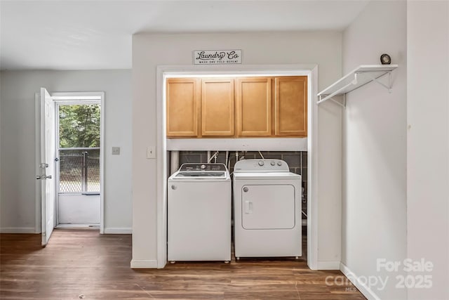 207 Jacksons Run, Morganton, NC 28655 - washroom featuring washing machine and clothes dryer, cabinet space, and wood finished floors