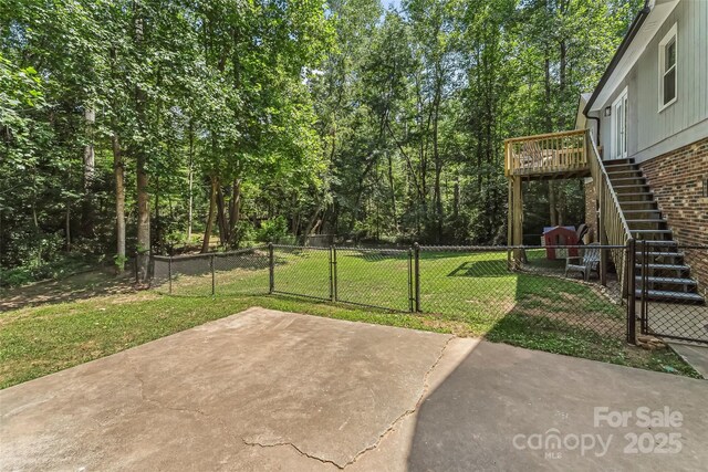 207 Jacksons Run, Morganton, NC 28655 - fenced yard featuring stairway, a gate, and a patio area