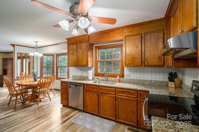 14409 Hackamore Dr, Matthews, NC 28105 - kitchen featuring crown molding, appliances with stainless steel finishes, brown cabinetry, a ceiling fan, and wallpapered walls