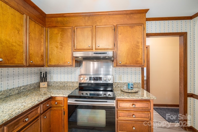 14409 Hackamore Dr, Matthews, NC 28105 - kitchen featuring stainless steel electric stove, under cabinet range hood, wallpapered walls, brown cabinets, and ornamental molding