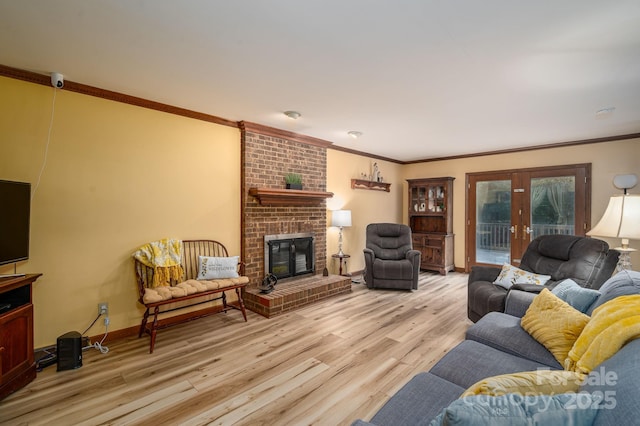 14409 Hackamore Dr, Matthews, NC 28105 - living area with light wood-type flooring, a brick fireplace, crown molding, and french doors