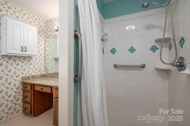 14409 Hackamore Dr, Matthews, NC 28105 - bathroom featuring wallpapered walls, a tile shower, vanity, and tile patterned floors