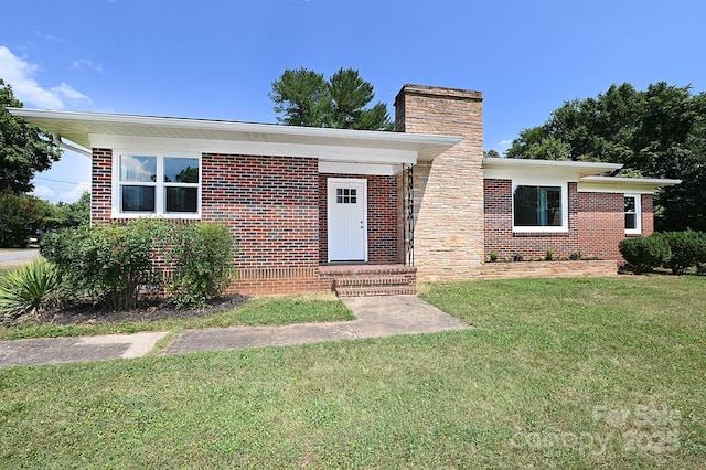 737 8th St SW, Hickory, NC 28602 - view of front of home with a chimney, a front yard, and brick siding