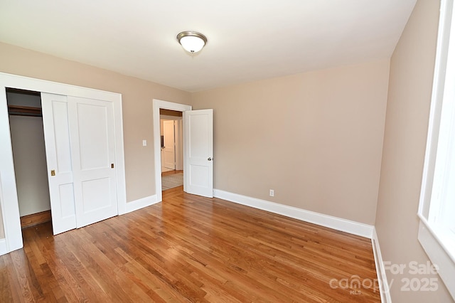 737 8th St SW, Hickory, NC 28602 - unfurnished bedroom with light wood-type flooring and a closet