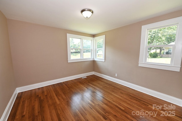 737 8th St SW, Hickory, NC 28602 - empty room featuring plenty of natural light and dark wood-style floors