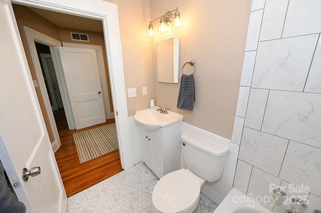 737 8th St SW, Hickory, NC 28602 - bathroom featuring vanity, a tub, and wood finished floors