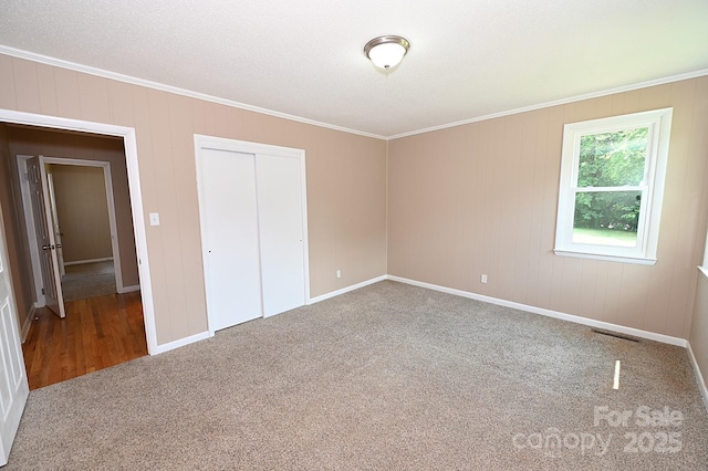737 8th St SW, Hickory, NC 28602 - unfurnished bedroom featuring carpet, crown molding, and a closet
