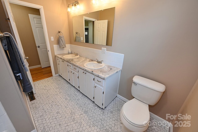 737 8th St SW, Hickory, NC 28602 - bathroom featuring double vanity and decorative backsplash