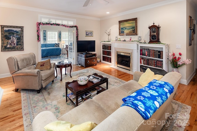122 Hazeltine Ct, Salisbury, NC 28144 - living area featuring crown molding, wood finished floors, ceiling fan, a fireplace with flush hearth, and recessed lighting