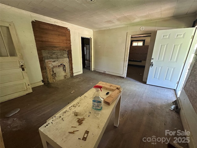 301 Weant St, Salisbury, NC 28144 - unfurnished living room featuring ornamental molding, wood-type flooring, and a fireplace with flush hearth