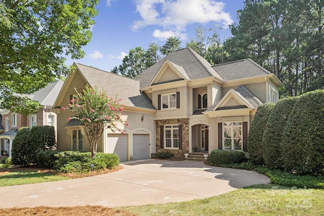18802 Pentwater Ct, Cornelius, NC 28031 - view of front of property featuring stucco siding, a garage, concrete driveway, a shingled roof, and stone siding