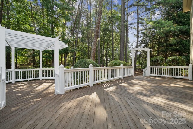 18802 Pentwater Ct, Cornelius, NC 28031 - wooden terrace featuring a pergola and view of scattered trees